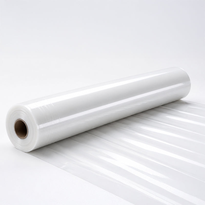 A roll of clear plastic sheeting lies on a white surface.
